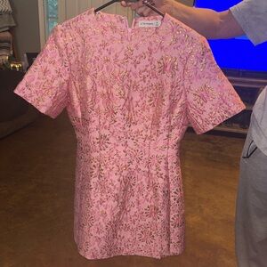 Pink boutique dress with gold detail.